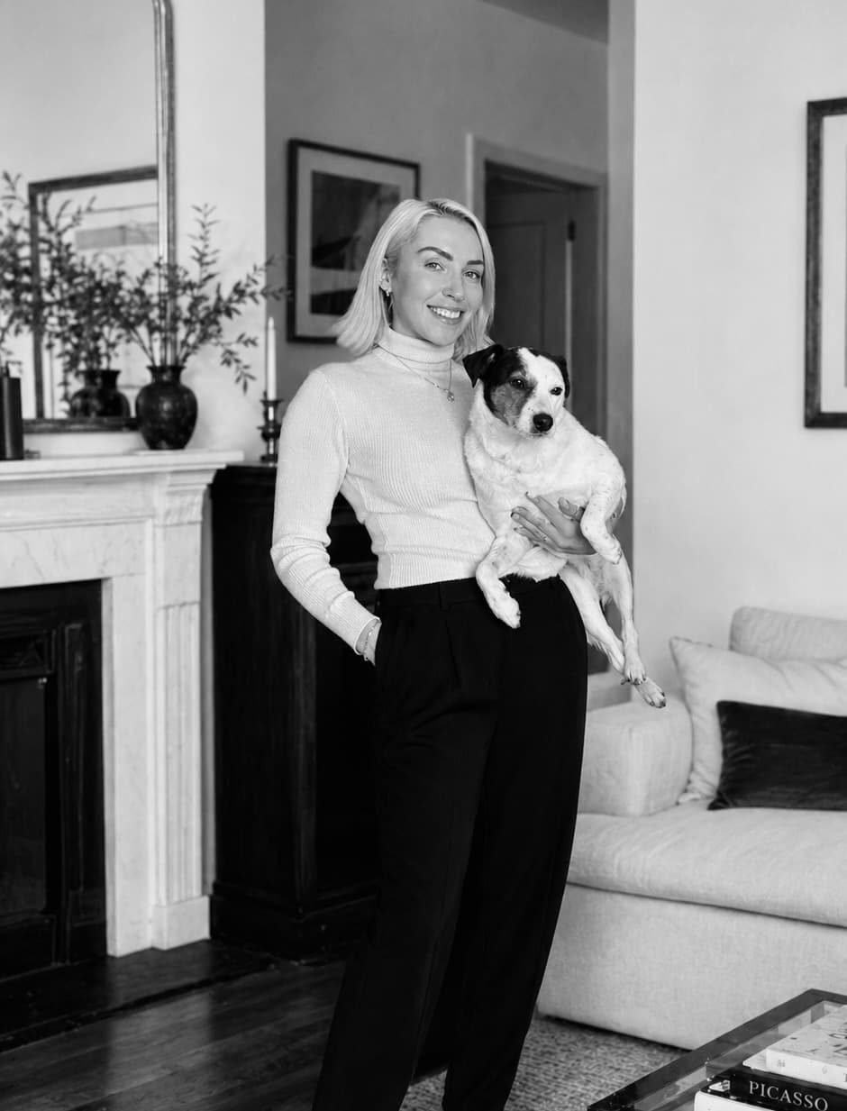 Natalie, founder of Frankie & Paws, working at her desk in black and white