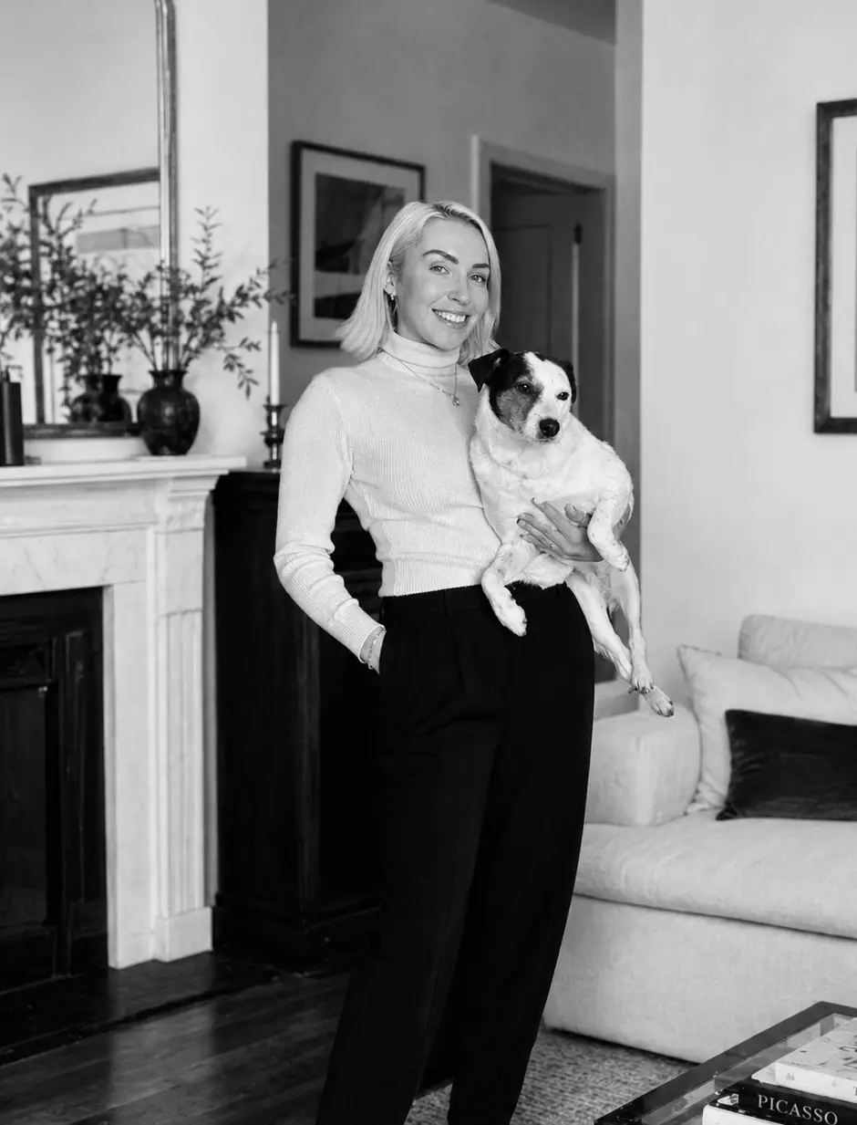 Natalie, founder of Frankie & Paws, working at her desk in black and white