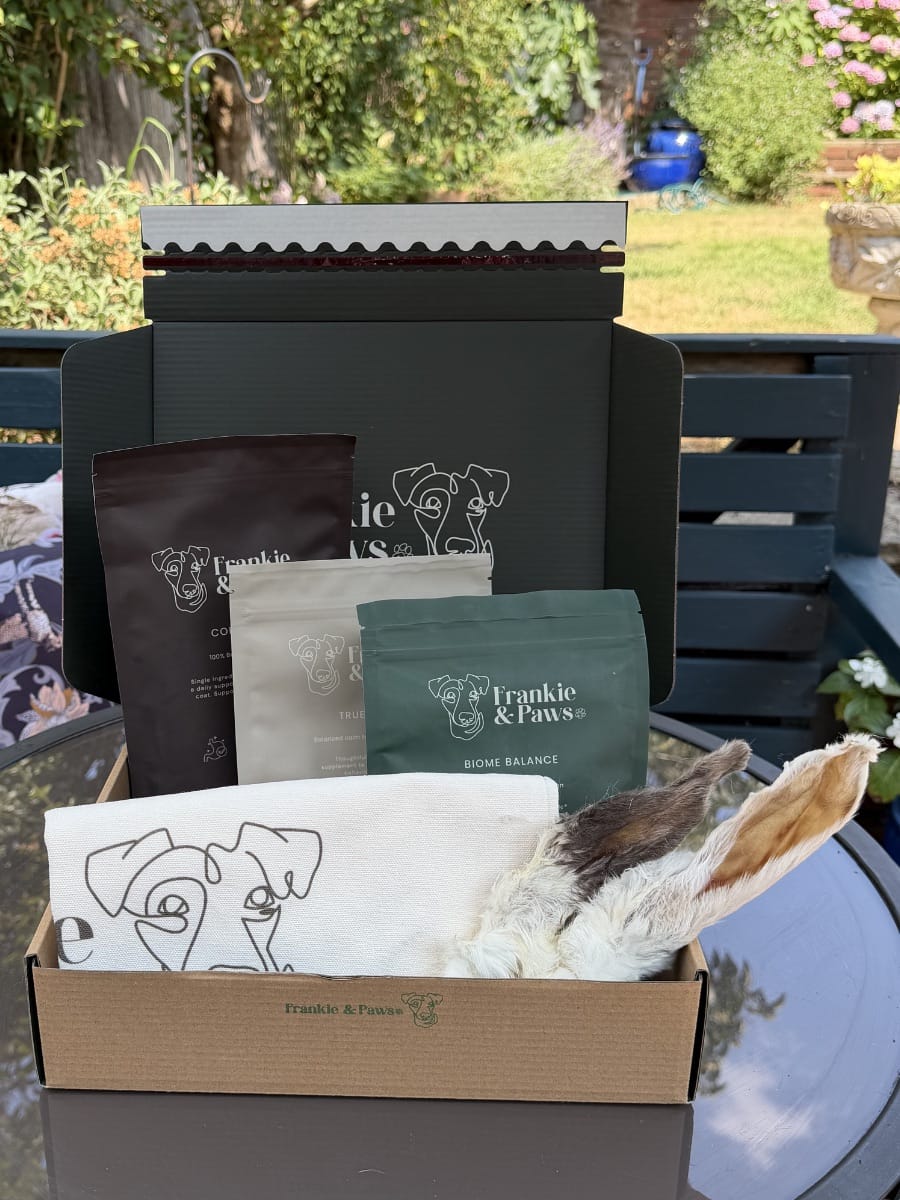 The Complete Wellness Collection gift box with Collagen, True Calm and Biome Balance supplements, a printed cloth and natural rabbit-ear treats